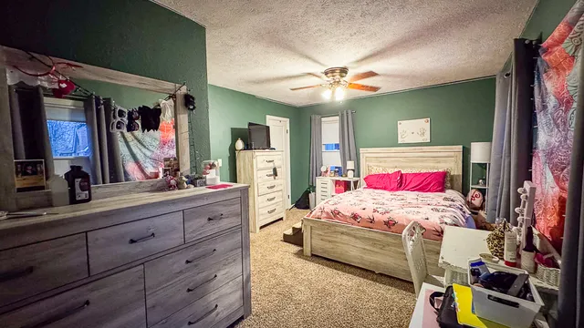 a bedroom with a bed and a mirror