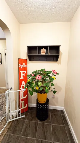 a glass vase with flowers on the floor