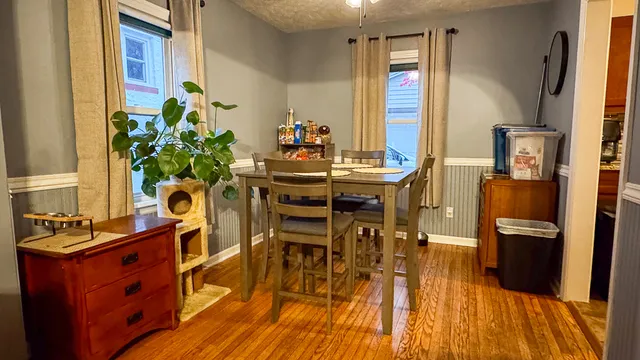 a dining room with furniture and wooden floor
