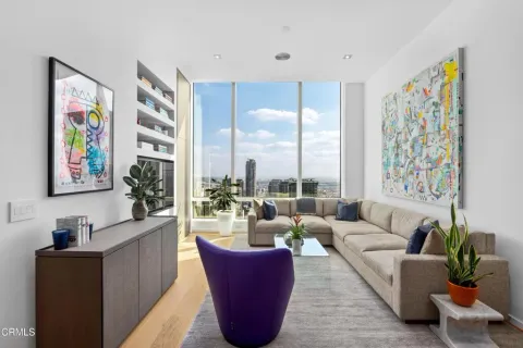 a living room with furniture and large windows