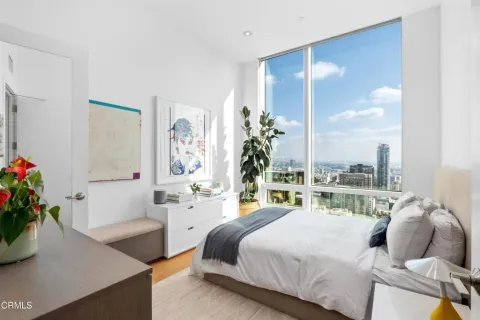 a bedroom with a bed and a couch