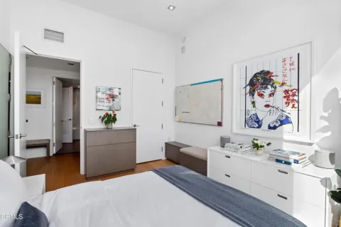 a bedroom with a bed and a furniture