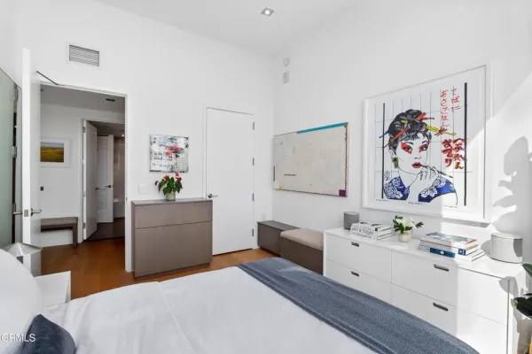 a bedroom with a bed and a furniture