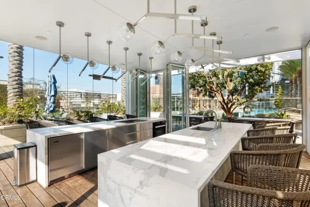 a very nice looking room with a large window and stainless steel appliances