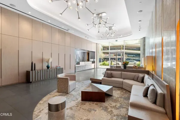 a living room with furniture and a chandelier