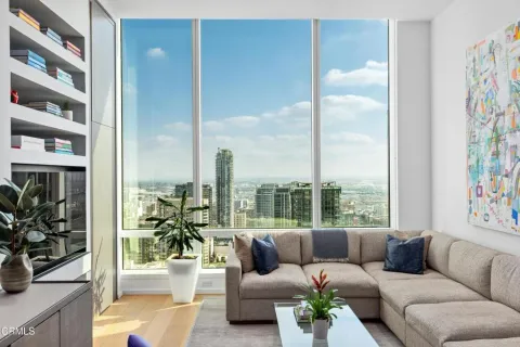 a living room with furniture and a floor to ceiling window