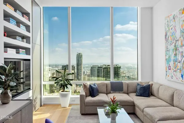 a living room with furniture and a floor to ceiling window