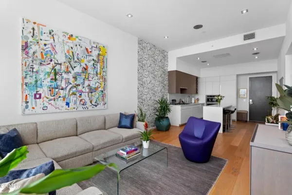 a living room with furniture and wooden floor