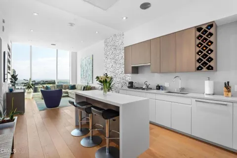a kitchen with a table chairs and a sink