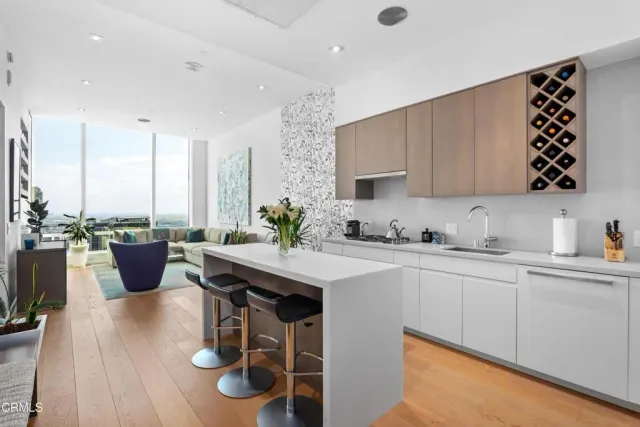 a kitchen with a table chairs and a sink