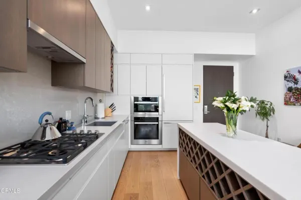 a kitchen with sink stove and cabinets