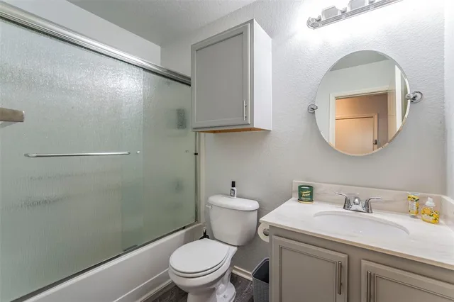a bathroom with a toilet a sink and a mirror