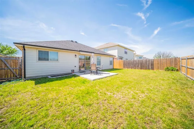 a swimming pool with outdoor seating and yard