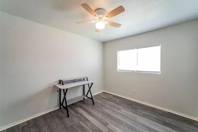 a view of a workspace with wooden floor