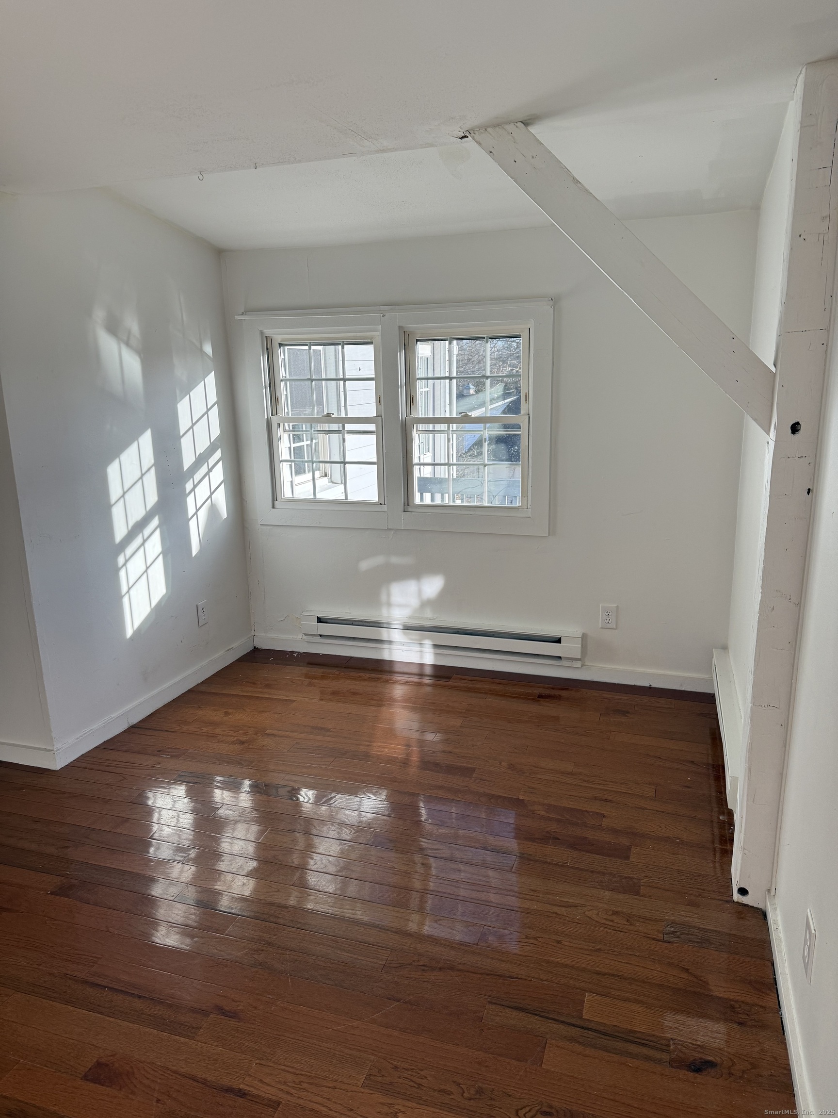 2 Straits Turnpike Lane, Unit B Morris, CT 06763 - Photo 3 of 8 a view of empty room with wooden floor and fan