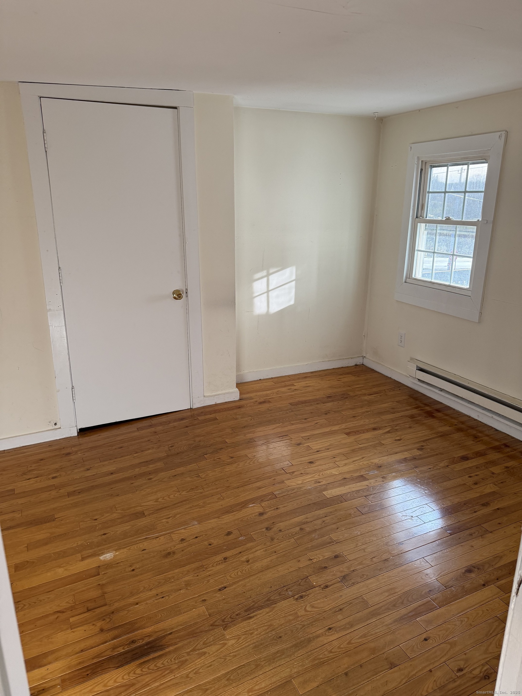 2 Straits Turnpike Lane, Unit B Morris, CT 06763 - Photo 4 of 8 a view of an empty room with wooden floor and a window