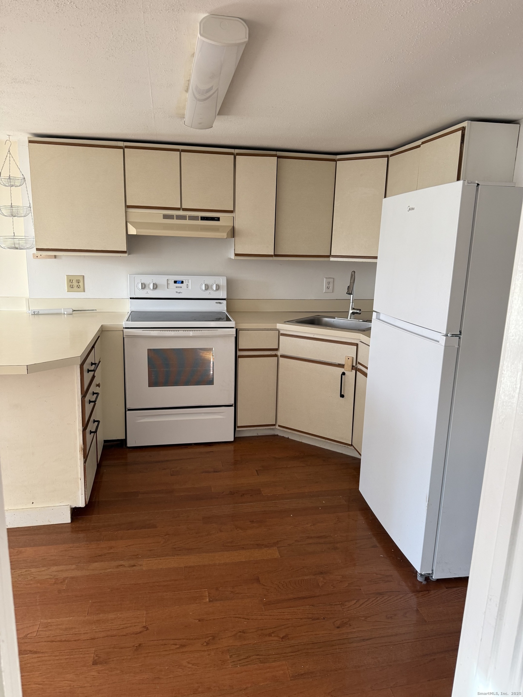 2 Straits Turnpike Lane, Unit B Morris, CT 06763 - Photo 5 of 8 a kitchen with a stove a sink and a refrigerator