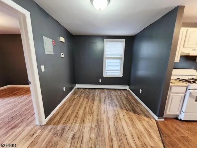 a view of a room with wooden floor and window