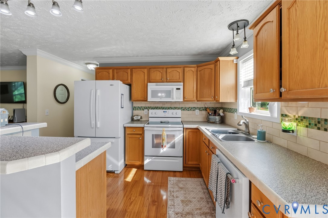 10910 Courthouse Road Dinwiddie, VA 23841 - Photo 10 of 38 Kitchen featuring wood-finish cabinetry, white app
