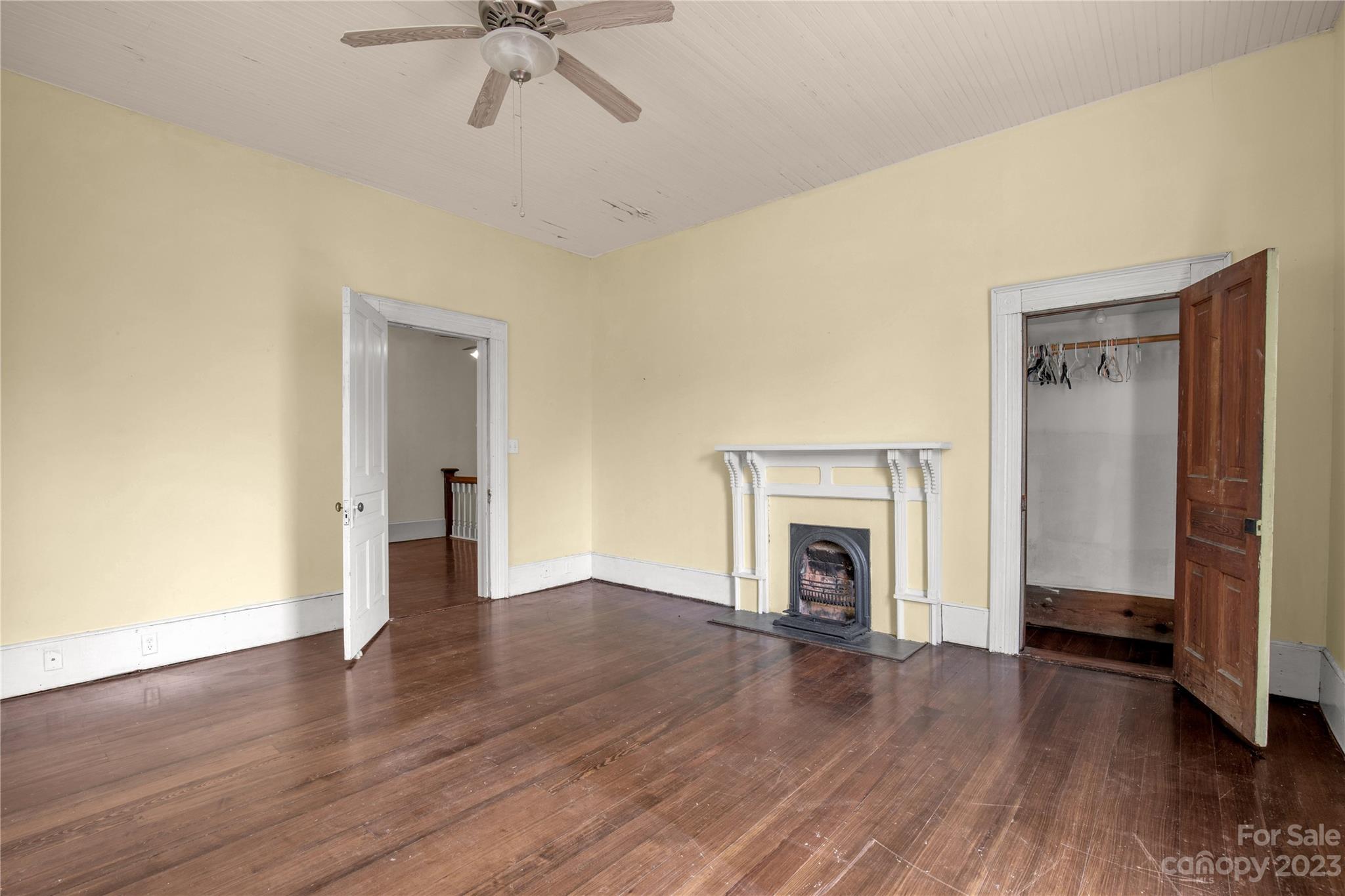 205 Walnut Street Chester, SC 29706 - Photo 26 of 32 an empty room with wooden floor fireplace and windows