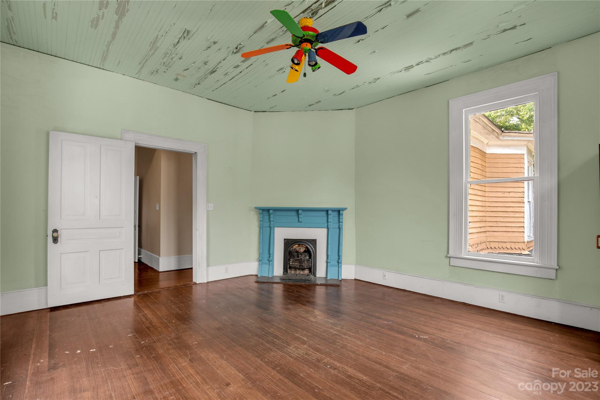 205 Walnut Street Chester, SC 29706 - Photo 30 of 32 an empty room with wooden floor fireplace and windows