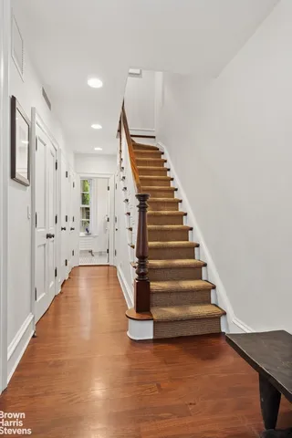 a living room with furniture and a large window with garden view