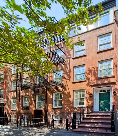 a view of a balcony with chairs and a potted plant