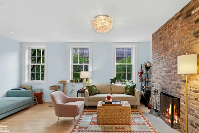 a living room with stainless steel appliances kitchen island granite countertop furniture and a flat screen tv