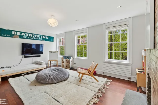 a spacious bedroom with a bed and a fireplace
