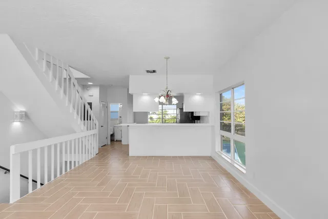 a kitchen with stainless steel appliances a sink a counter top space cabinets and a potted plant