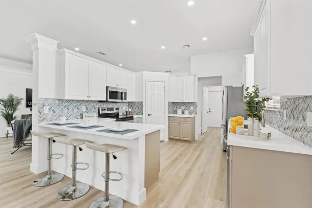 a kitchen with stainless steel appliances granite countertop a sink and cabinets