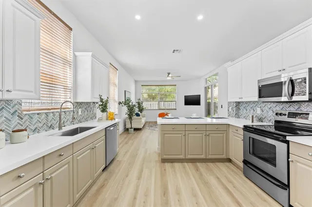 a kitchen with a sink stove and microwave
