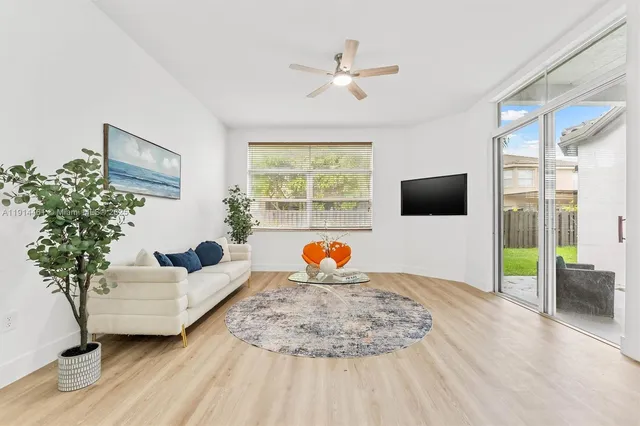 a living room with furniture and a flat screen tv