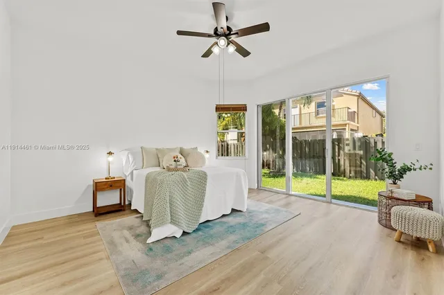 a living room with furniture and a floor to ceiling window