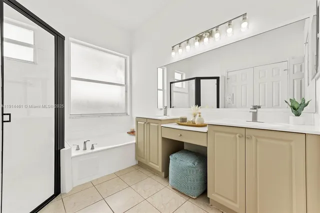 a bathroom with a tub sink and mirror