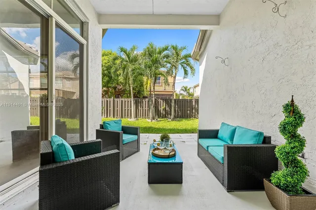 a garden view with a seating space and a potted plant
