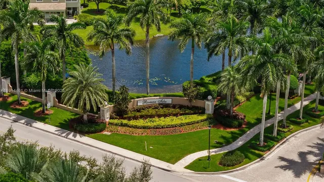 a front view of a house with a yard and potted plants