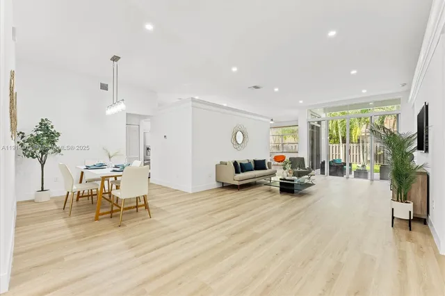 a living room with furniture and a table with wooden floor
