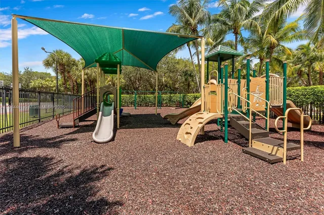 a living room with patio furniture and a large window