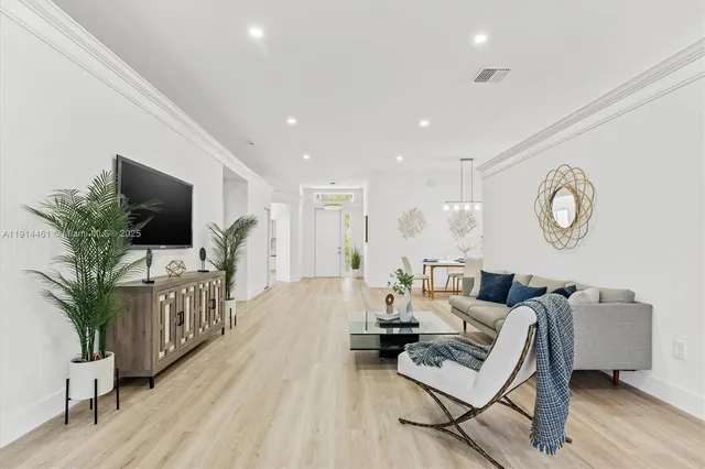 a living room with furniture a large window and a flat screen tv