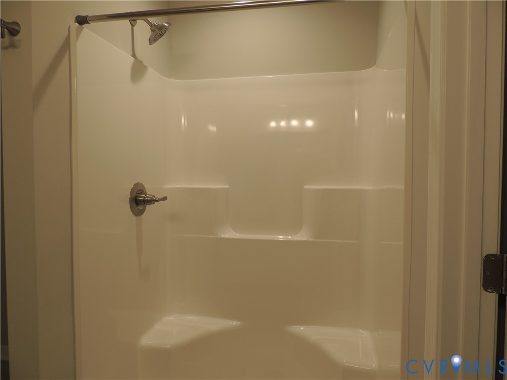 4417 Olgers Road Sutherland, VA 23885 - Photo 17 of 24 White fiberglass shower surround featuring integra
