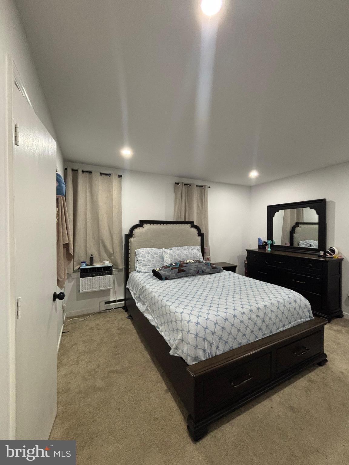 6004 Simplicity Court Chesterfield, VA 23832 - Photo 7 of 17 a spacious bedroom with a bed and a dresser with mirror
