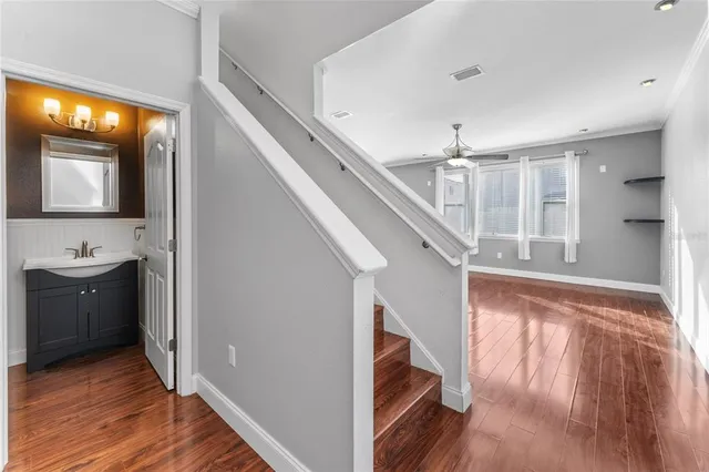 a view of entryway and hall with wooden floor