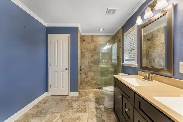 a bathroom with a granite countertop sink a large mirror and a shower