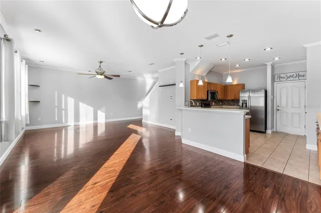 a view of a kitchen with cabinets and wooden floor