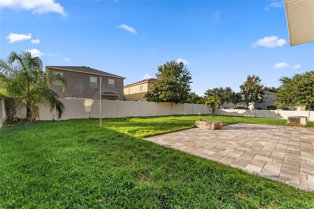 a view of a yard with a house in the background