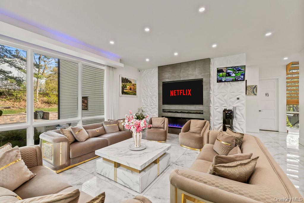 5 Bluebird Road Monsey, NY 10952 - Photo 11 of 50 a living room with furniture a fireplace and a flat screen tv