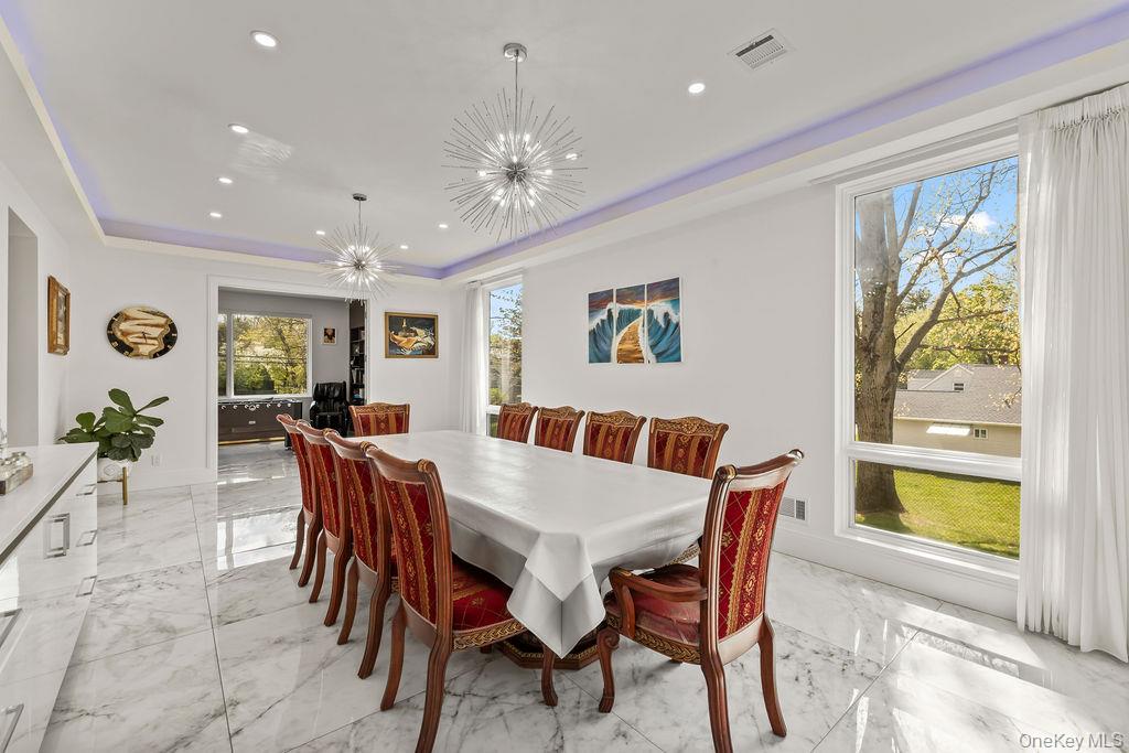 5 Bluebird Road Monsey, NY 10952 - Photo 13 of 50 a view of a dining room with furniture a livingroom and chandelier