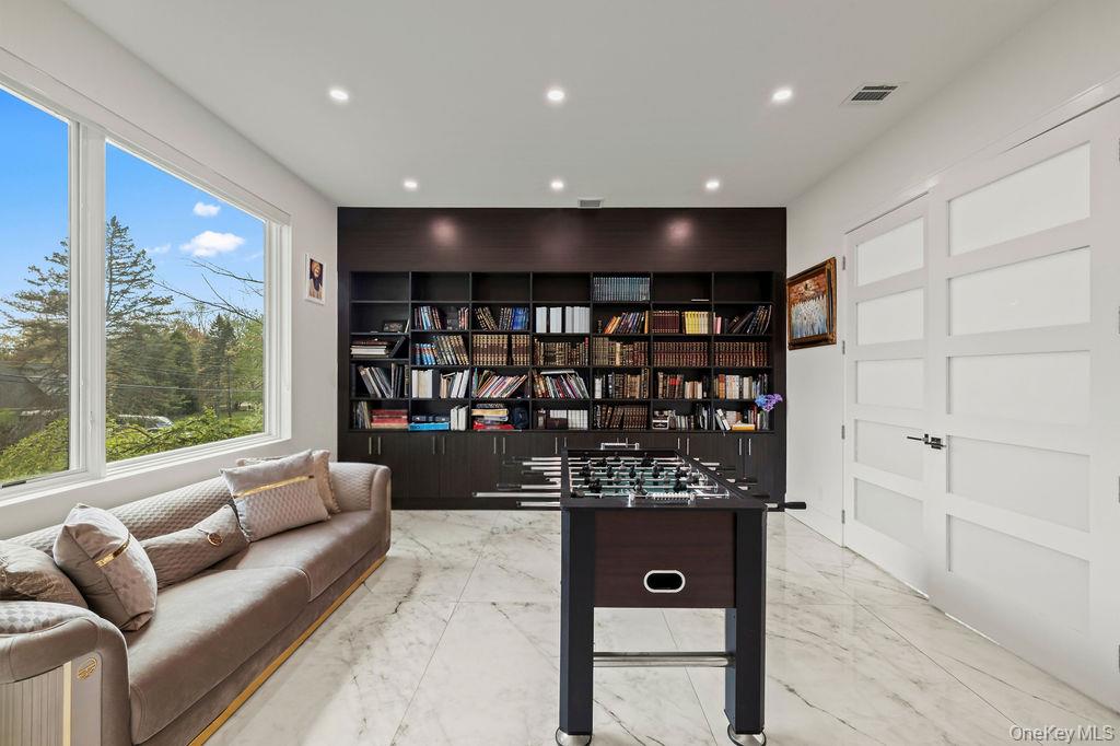 5 Bluebird Road Monsey, NY 10952 - Photo 17 of 50 a living room with a couch and a bookshelf