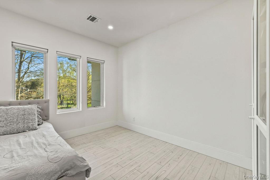 5 Bluebird Road Monsey, NY 10952 - Photo 28 of 50 a large bedroom with a bed and a window